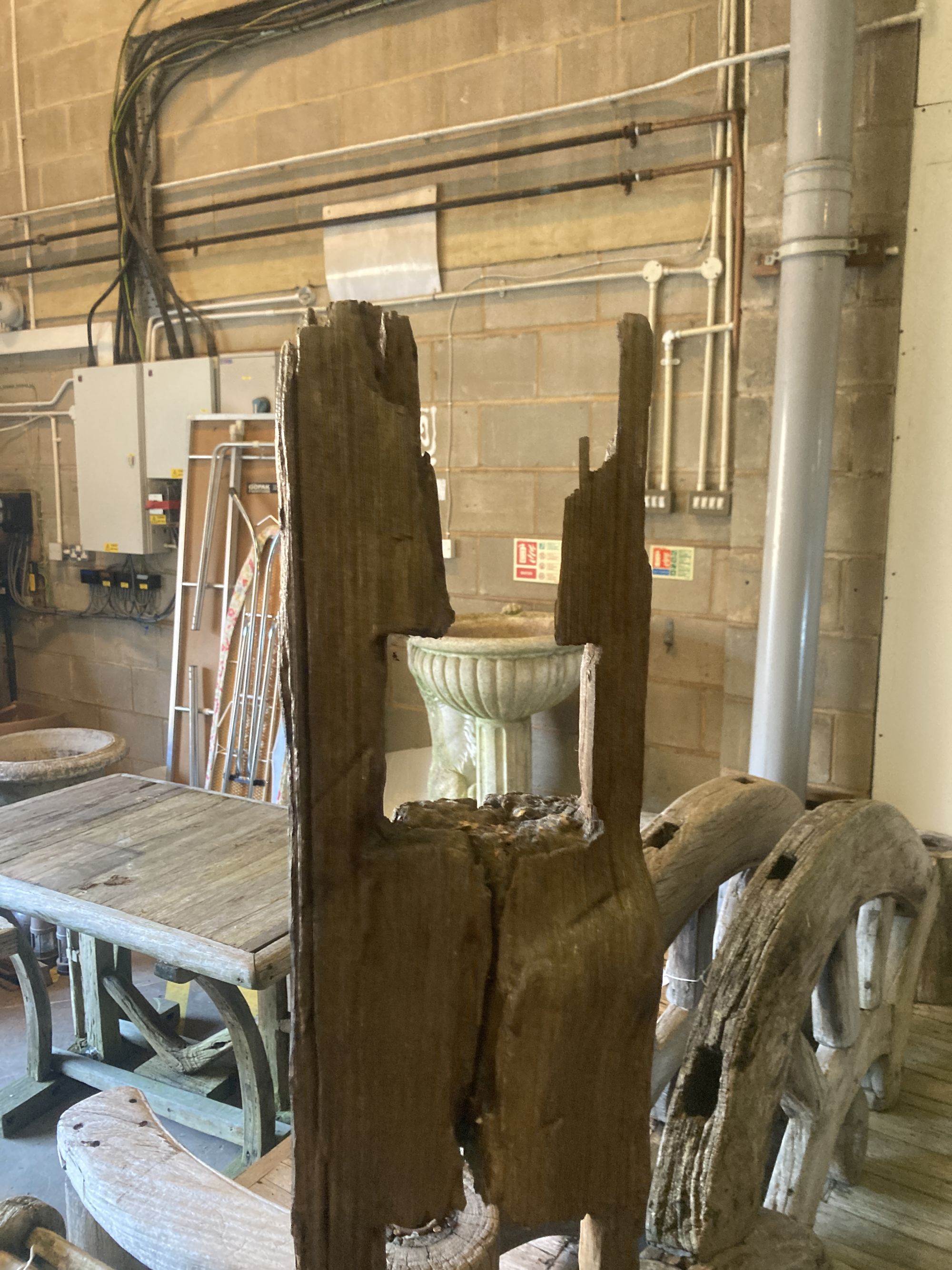 A weathered hardwood cartwheel and reclaimed timber garden seat, width 88cm depth 70cm height 170cm